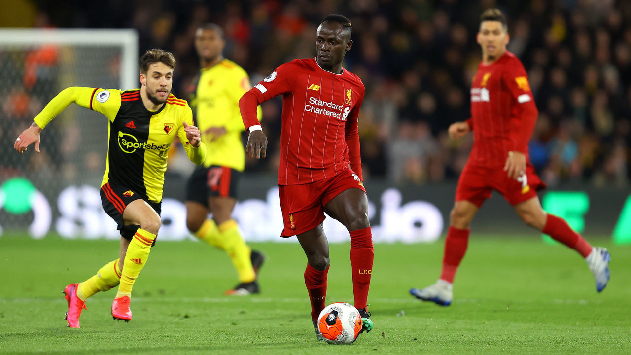WATFORD, ENGLAND - FEBRUARY 29: Sadio Mane of Liverpool is put under pressure by Kiko Femenia of Watford during the Premier League match between Watford FC and Liverpool FC at Vicarage Road on February 29, 2020 in Watford, United Kingdom.