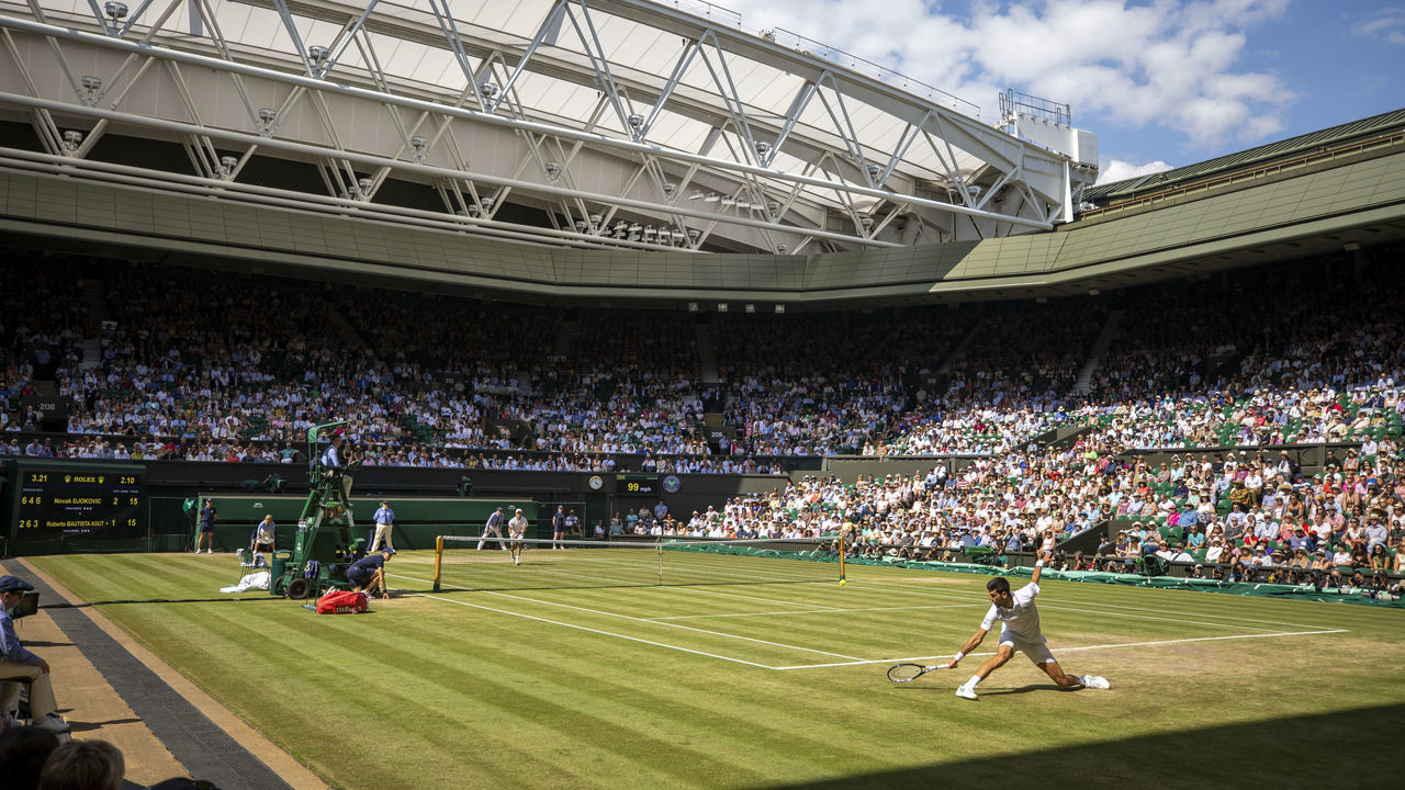 LONDON, ENGLAND - July 12: A general view of Novak Djokovic of Serbia in action against Roberto Bautista Agut of Spain during the Men's Singles Semifinals on Centre Court during the Wimbledon Lawn Tennis Championships at the All England Lawn Tennis and Croquet Club at Wimbledon on July 12, 2019 in London, England.