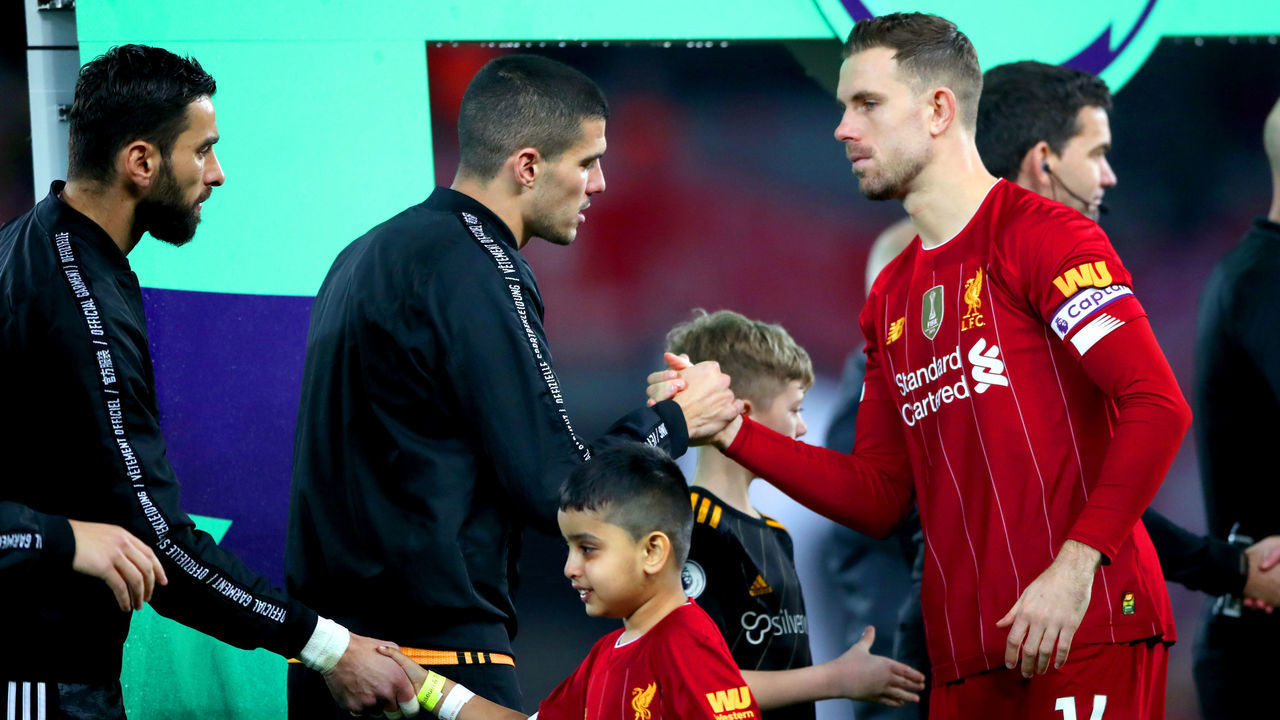 Liverpool's Jordan Henderson (right) shakes hands with Wolverhampton Wanderers' Conor Coady prior to the beginning of the Premier League match at Anfield Stadium, Liverpool.