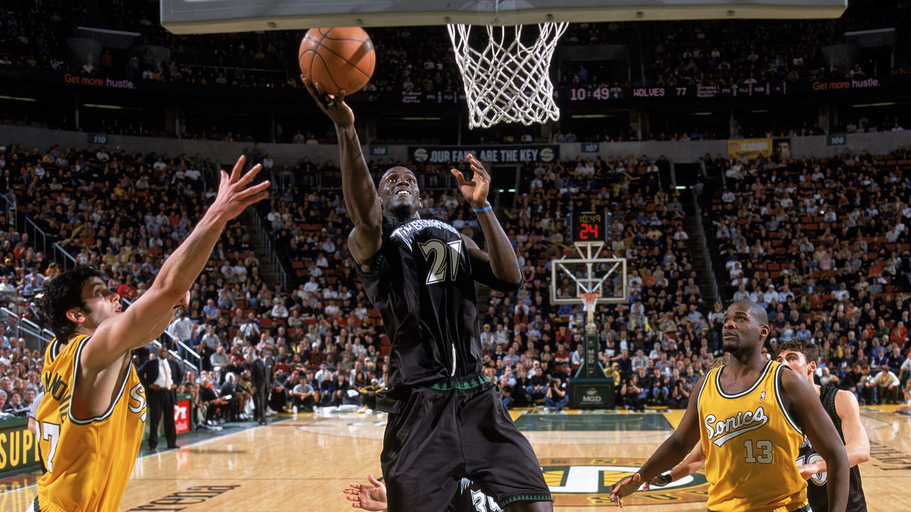 SEATTLE - MARCH 9: Kevin Garnett #21 of the Minnesota Timberwolves goes in for a layup against Vladimir Radmanovic #77 of the Seattle Sonics during the game at Key Arena on March 9, 2004 in Seattle, Washington. The Timberwolves won 105-92. NOTE TO USER: User expressly acknowledges and agrees that, by downloading and/or using this Photograph, User is consenting to the terms and conditions of the Getty Images License Agreement.