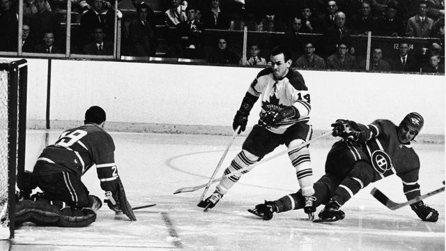 Dave Koen of the Toronto Maple Leafs (#14) (center) tries to elude the Montreal Canadien defense and goalkeeper Rogatien Vachon (left), during the second game of the 1967 Stanley Cup finals, Montreal, Quebec, Canada, April 22, 1967.