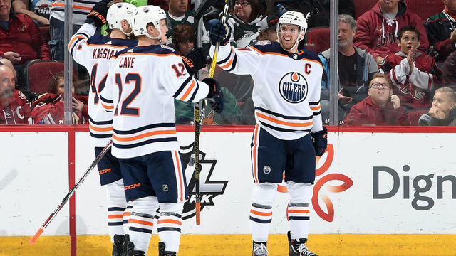 GLENDALE, AZ - MARCH 16: Connor McDavid #97 of the Edmonton Oilers celebrates with teammates Zack Kassian #44 and Colby Cave #12 after scoring the game winning goal in overtime against the Arizona Coyotes at Gila River Arena on March 16, 2019 in Glendale, Arizona. The Oilers defeated the Coyotes 3-2.
