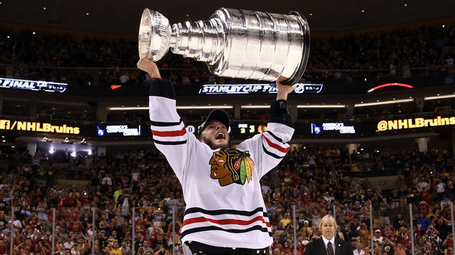 BOSTON, MA - JUNE 24: Jonathan Toews #19 of the Chicago Blackhawks hoist the Stanley Cup Trophy after defeating the Boston Bruins in Game Six of the 2013 NHL Stanley Cup Final at TD Garden on June 24, 2013 in Boston, Massachusetts. The Chicago Blackhawks defeated the Boston Bruins 3-2.