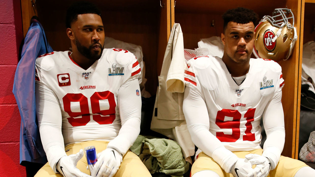 MIAMI, FLORIDA - FEBRUARY 2: DeForest Buckner #99 and Arik Armstead #91 of the San Francisco 49ers sit in the locker room before the game against the Kansas City Chiefs in Super Bowl LIV at Hard Rock Stadium on February 2, 2020 in Miami, Florida. The Chiefs defeated the 49ers 31-20.