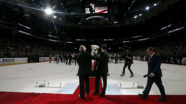 BOSTON, MASSACHUSETTS - JUNE 12: Phil Pritchard, left and Craig Campbell the Keepers of the Stanley Cup, bring the cup onto the ice after Game Seven of the 2019 NHL Stanley Cup Final between the Boston Bruins and the St. Louis Blues at TD Garden on June 12, 2019 in Boston, Massachusetts.