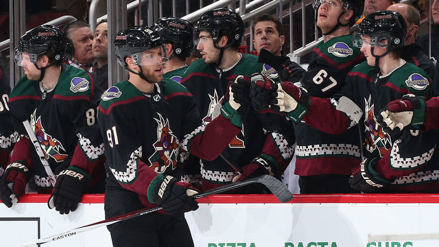 GLENDALE, ARIZONA - JANUARY 12: Taylor Hall #91 of the Arizona Coyotes celebrates with teammates on the bench after scoring against the Pittsburgh Penguins during the second period of the NHL game at Gila River Arena on January 12, 2020 in Glendale, Arizona.