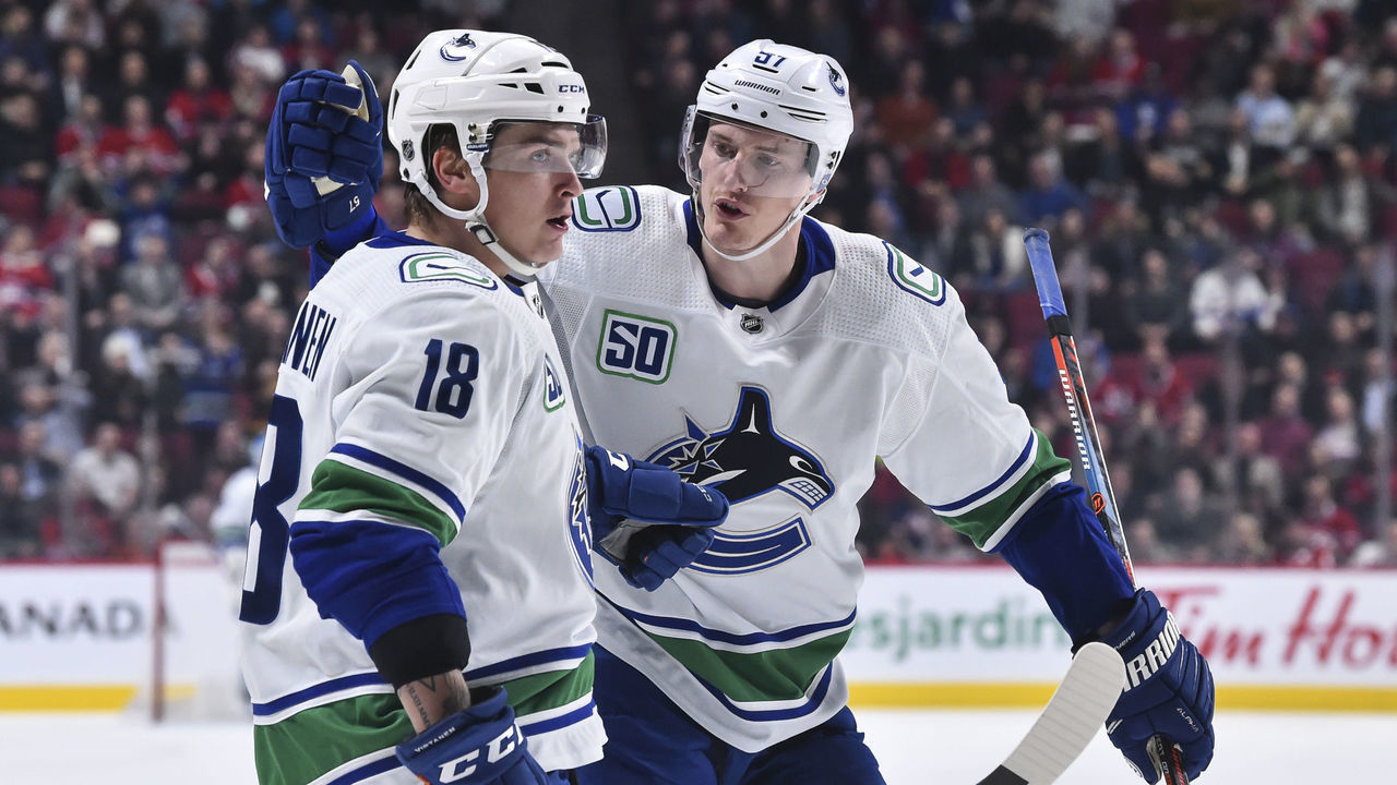 MONTREAL, QC - FEBRUARY 25: Jake Virtanen #18 of the Vancouver Canucks celebrates his goal with teammate Tyler Myers #57 during the third period against the Montreal Canadiens at the Bell Centre on February 25, 2020 in Montreal, Canada. The Vancouver Canucks defeated the Montreal Canadiens 4-3 in overtime.