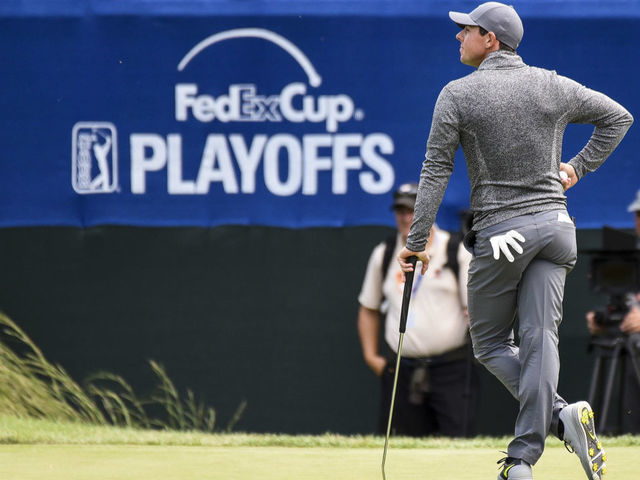 NORTON, MA - SEPTEMBER 05: Rory McIlroy of Northern Ireland stands near the FedExCup Playoffs logo on the 16th hole green during the final round of the Deutsche Bank Championship at TPC Boston on September 5, 2016 in Norton, Massachusetts.