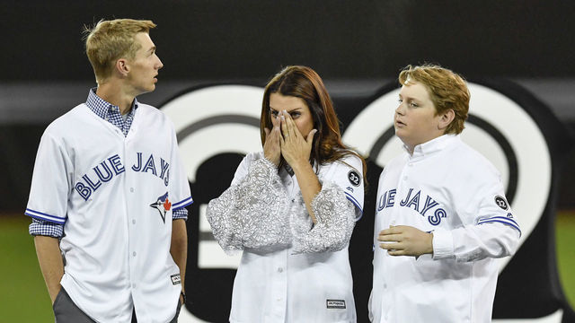 TORONTO, ON - MARCH 29: Roy Halladay's family, son Braden (L), wife Brandy and other son Ryan take in the emotion during a ceremony honoring the late pitcher by retiring his No. 32 on opening day before the MLB season game between the New York Yankees and the Toronto Blue Jays at Rogers Centre in Toronto, ON., Canada March 29, 2018. Jays players will also wear a no. 32 patch on their jerseys throughout the season in tribute to Halladay. Halladay, nicknamed 'Doc' who spent 12 seasons as a pitcher with the Jays, died in November 2017 when his personal plane crashed into the Gulf of Mexico near Tampa. He was 40 years old. Halladay joins Robero Alomar (no. 12) as the only 2 players in Jays history to have their jersey numbers retired.