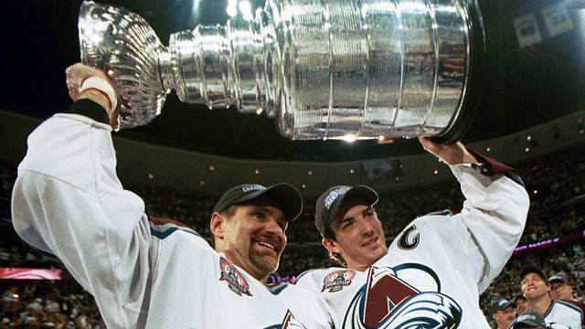DENVER, COLORADO - JUNE 9: Ray Bourque #77 of the Colorado Avalanche lifts the cup with Joe Sakic #19 after the Colorado Avalanche defeated the New Jersey Devils 3-1 in game seven of the NHL Stanley Cup Finals at Pepsi Center in Denver, Colorado. The Avalanche take the series 4-3.