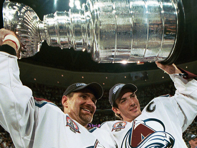 DENVER, COLORADO - JUNE 9: Ray Bourque #77 of the Colorado Avalanche lifts the cup with Joe Sakic #19 after the Colorado Avalanche defeated the New Jersey Devils 3-1 in game seven of the NHL Stanley Cup Finals at Pepsi Center in Denver, Colorado. The Avalanche take the series 4-3.