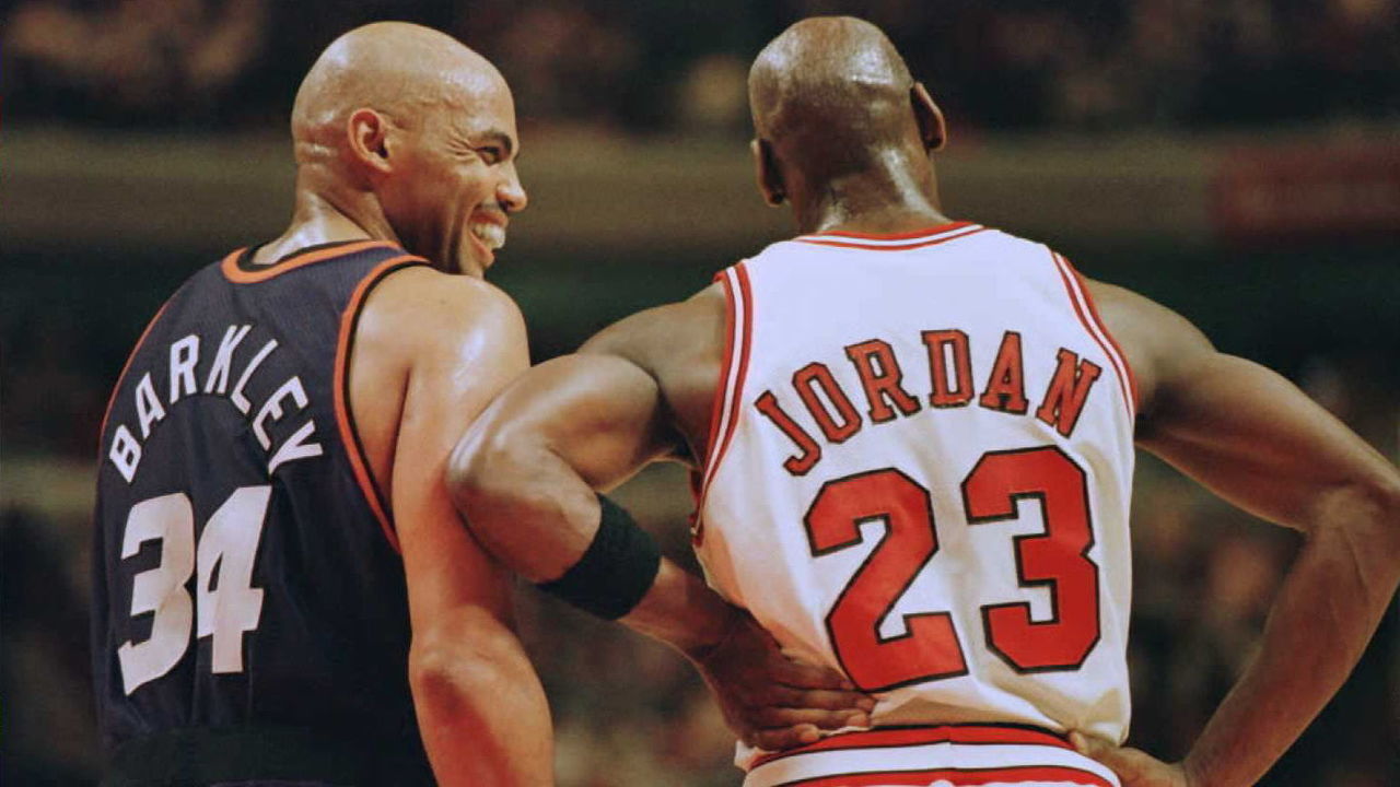Phoenix Suns forward Charles Barkley (34) laughs at a foul call with Chicago Bulls guard Michael Jordan (23) in the first half 28 January 1996 at the United Center in Chicago. The Bulls won 93-82. Jordan scored 31 points, and Barkley scored 20 with 16 rebounds. AFP PHOTO Brian BAHR