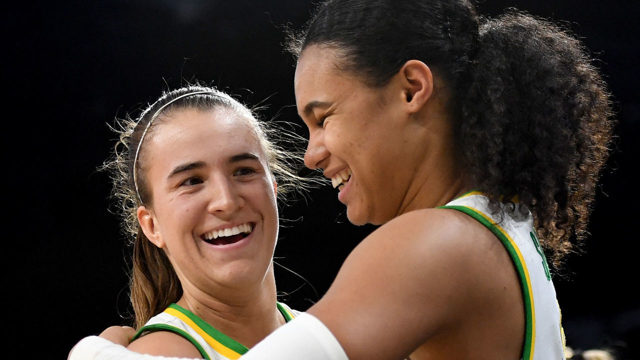 LAS VEGAS, NEVADA - MARCH 08: Sabrina Ionescu #20 and Satou Sabally #0 of the Oregon Ducks hug as they come out of the game late in their 89-56 victory over the Stanford Cardinal during the championship game of the Pac-12 Conference women's basketball tournament at the Mandalay Bay Events Center on March 8, 2020 in Las Vegas, Nevada.