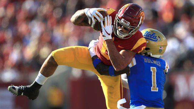 LOS ANGELES, CALIFORNIA - NOVEMBER 23: Darnay Holmes #1 of the UCLA Bruins defends as Michael Pittman Jr. #6 of the USC Trojans makes a catch during the first half of a game at Los Angeles Memorial Coliseum on November 23, 2019 in Los Angeles, California.