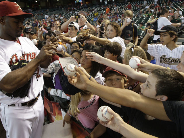 HOUSTON,TX- JULY 20: Center fielder Michael Bourn #21 of the Houston Astros signs autographs before the Astros played against the Washington Nationals on July 20, 2011 at Minute Maid Park in Houston, Texas. Astros won in the bottom of the 11th 3 to 2.