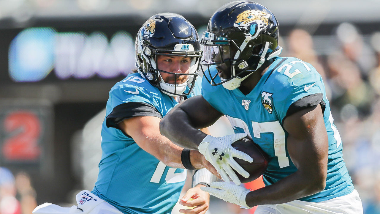 JACKSONVILLE, FLORIDA - OCTOBER 13: Gardner Minshew #15 of the Jacksonville Jaguars hands off the ball to Leonard Fournette #27 during the first quarter of a game against the New Orleans Saints at TIAA Bank Field on October 13, 2019 in Jacksonville, Florida.