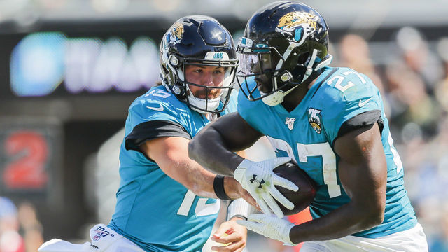 JACKSONVILLE, FLORIDA - OCTOBER 13: Gardner Minshew #15 of the Jacksonville Jaguars hands off the ball to Leonard Fournette #27 during the first quarter of a game against the New Orleans Saints at TIAA Bank Field on October 13, 2019 in Jacksonville, Florida.