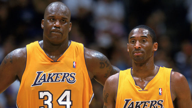 LOS ANGELES - APRIL 17: Shaquille O'Neal #34 and Kobe Bryant #8 of the Los Angeles Lakers wait for play to resume in Game One of the Western Conference Quarterfinals against the Houston Rockets during the 2004 NBA Playoffs at Staples Center on Aril 17, 2004 in Los Angeles, California. The Lakers won 72-71. NOTE TO USER: User expressly acknowledges and agrees that, by downloading and/or using this Photograph, User is consenting to the terms and conditions of the Getty Images License Agreement. Mandatory Copyright Notice: Copyright 2004 NBAE
