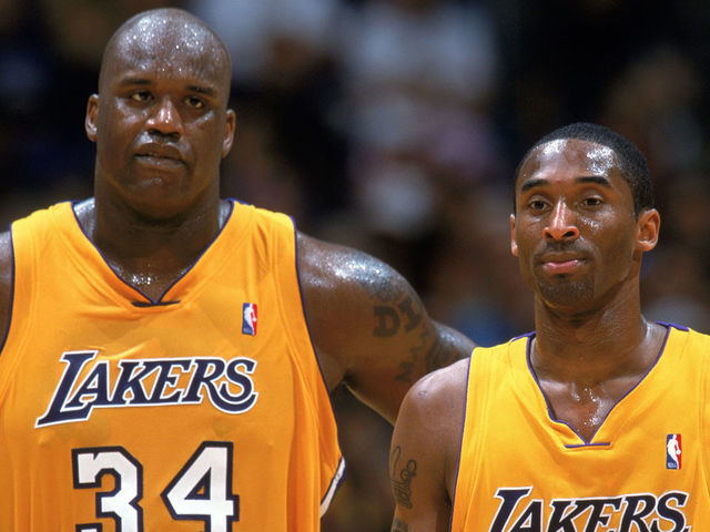 LOS ANGELES - APRIL 17: Shaquille O'Neal #34 and Kobe Bryant #8 of the Los Angeles Lakers wait for play to resume in Game One of the Western Conference Quarterfinals against the Houston Rockets during the 2004 NBA Playoffs at Staples Center on Aril 17, 2004 in Los Angeles, California. The Lakers won 72-71. NOTE TO USER: User expressly acknowledges and agrees that, by downloading and/or using this Photograph, User is consenting to the terms and conditions of the Getty Images License Agreement. Mandatory Copyright Notice: Copyright 2004 NBAE