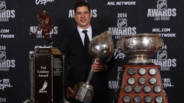 LAS VEGAS, NV - JUNE 24: Sidney Crosby of the Pittsburgh Penguins poses with the Ted Lindsay Award, the Hart Memorial Trophy, and the Art Ross Trophy during the 2014 NHL Awards at the Encore Theater at Wynn Las Vegas on June 24, 2014 in Las Vegas, Nevada.