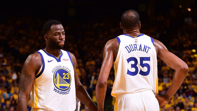 OAKLAND, CA - APRIL 13: Draymond Green #23 of the Golden State Warriors high-fives Kevin Durant #35 of the Golden State Warriors against the LA Clippers during Game One of Round One of the 2019 NBA Playoffs on April 13, 2019 at ORACLE Arena in Oakland, California. NOTE TO USER: User expressly acknowledges and agrees that, by downloading and or using this photograph, user is consenting to the terms and conditions of Getty Images License Agreement. Mandatory Copyright Notice: Copyright 2019 NBAE