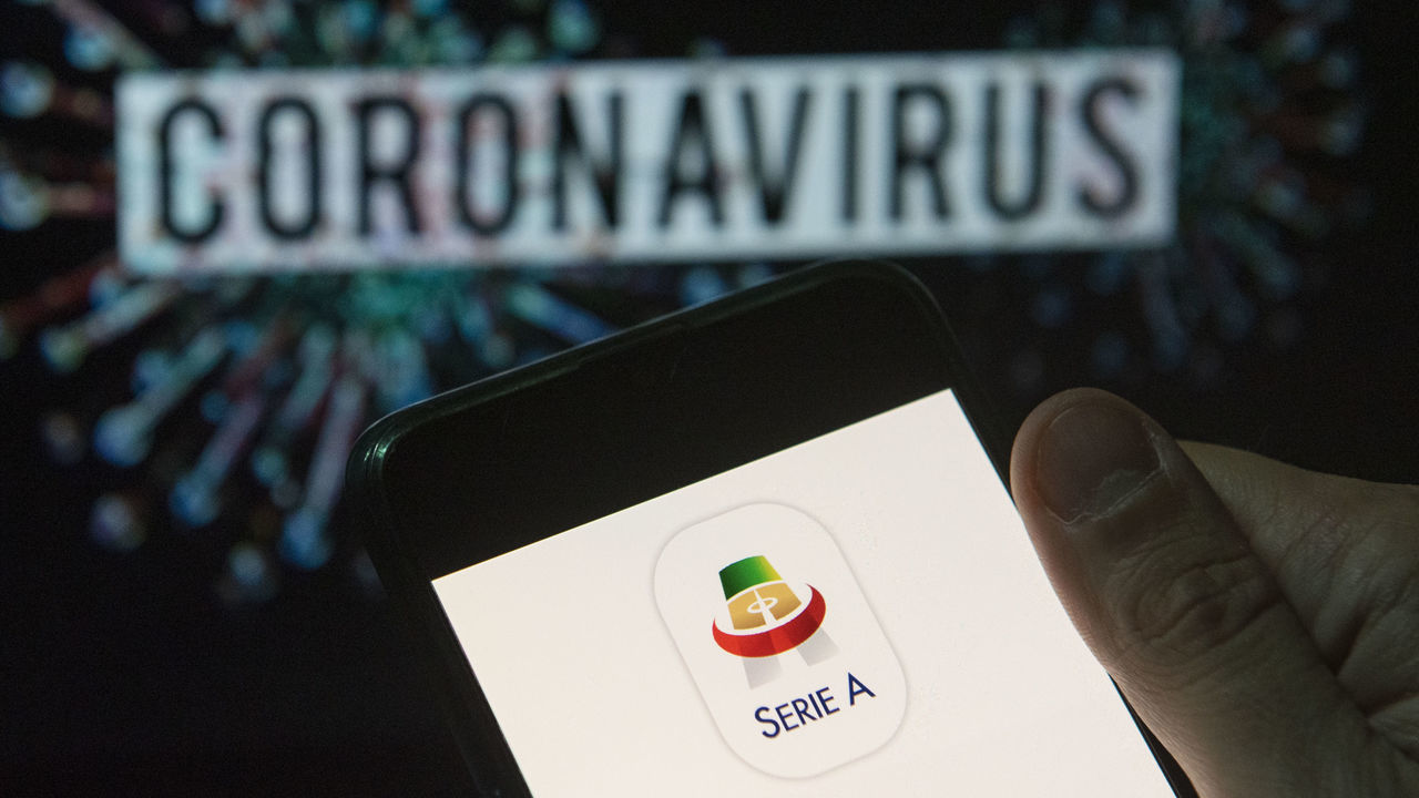 CHINA - 2020/03/24: In this photo illustration the Italian football professional top division Serie A logo seen displayed on a smartphone with a computer model of the COVID-19 coronavirus on the background. (Photo Illustration by Budrul Chukrut/SOPA Images/LightRocket via Getty Images)