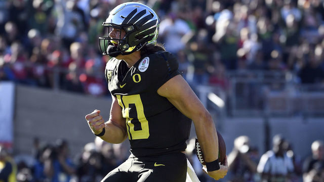 PASADENA, CALIFORNIA - JANUARY 01: Justin Herbert #10 of the Oregon Ducks celebrates after scoring a four yard touchdown against the Wisconsin Badgers during the first quarter in the Rose Bowl game presented by Northwestern Mutual at Rose Bowl on January 01, 2020 in Pasadena, California.