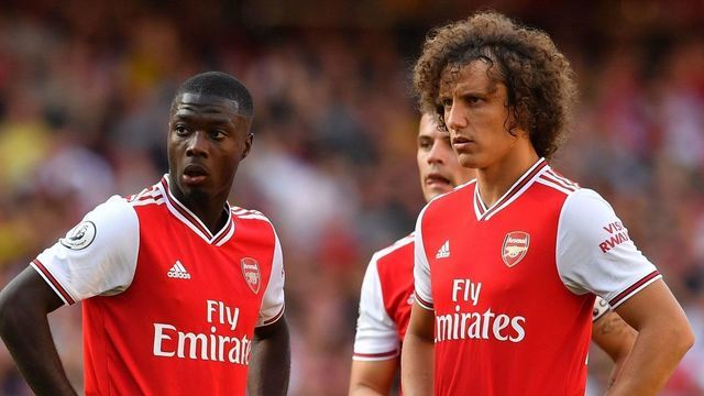 Arsenal's French-born Ivorian midfielder Nicolas Pepe (L), Arsenal's Swiss midfielder Granit Xhaka (C) and Arsenal's Brazilian defender David Luiz (R) stand over a freekick during the English Premier League football match between Arsenal and Tottenham Hotspur at the Emirates Stadium in London on September 1, 2019.