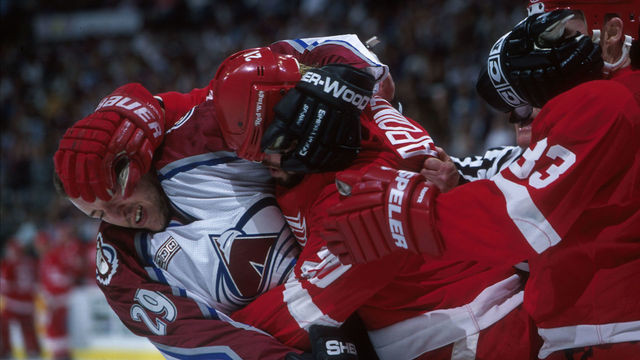 29 Apr 2000: Defenseman Eric Messier #29 of the Colorado Avalanche, left, battles right winger Martin LaPointe #20, center, and center Kris Draper #33 of the Detroit Red Wings during their Conference Semifinal game at the Pepsi Center in Denver, Colorado. Mandatory Credit: Brian Bahr/ALLSPORT