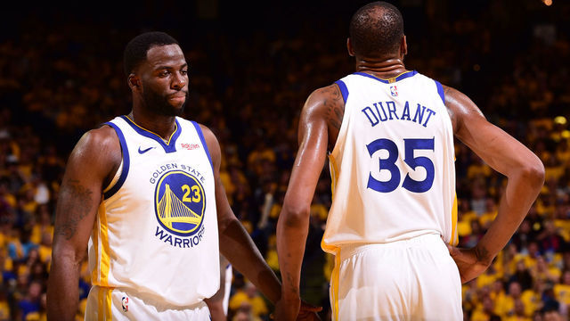 OAKLAND, CA - APRIL 13: Draymond Green #23 of the Golden State Warriors high-fives Kevin Durant #35 of the Golden State Warriors against the LA Clippers during Game One of Round One of the 2019 NBA Playoffs on April 13, 2019 at ORACLE Arena in Oakland, California. NOTE TO USER: User expressly acknowledges and agrees that, by downloading and or using this photograph, user is consenting to the terms and conditions of Getty Images License Agreement. Mandatory Copyright Notice: Copyright 2019 NBAE