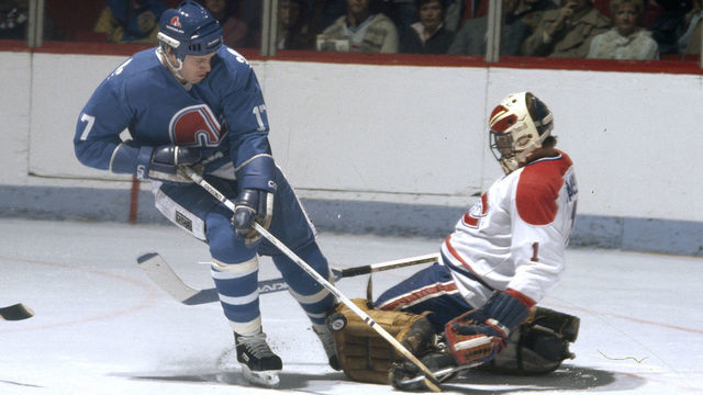 MONTREAL, CANADA- CIRCA 1982: Rick Wamsley #1 of the Montreal Canadiens makes a pad save on a shot by Tim Tookey #17 of the Quebec Nordiques Circa 1982 at the Montreal Forum in Montreal, Quebec, Canada.