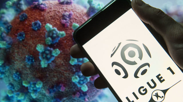 CHINA - 2020/03/23: In this photo illustration the French football professional division Ligue 1 logo seen displayed on a smartphone with a computer model of the COVID-19 coronavirus on the background. (Photo Illustration by Budrul Chukrut/SOPA Images/LightRocket via Getty Images)