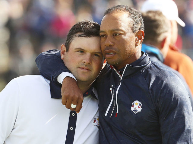 PARIS, FRANCE - SEPTEMBER 29: Tiger Woods of the United States consolls Patrick Reed of the United States following defeat during the morning fourball matches of the 2018 Ryder Cup at Le Golf National on September 29, 2018 in Paris, France.