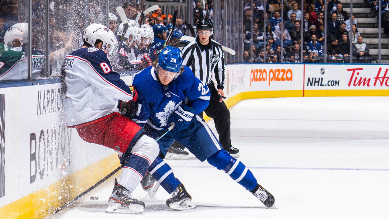 TORONTO, ON - OCTOBER 21: Kasperi Kapanen #24 of the Toronto Maple Leafs battles with Zach Werenski #8 of the Columbus Blue Jackets during the third period at the Scotiabank Arena on October 21, 2019 in Toronto, Ontario, Canada.