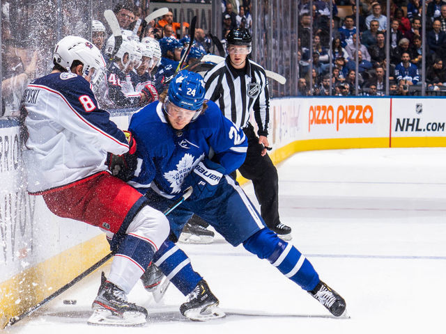 TORONTO, ON - OCTOBER 21: Kasperi Kapanen #24 of the Toronto Maple Leafs battles with Zach Werenski #8 of the Columbus Blue Jackets during the third period at the Scotiabank Arena on October 21, 2019 in Toronto, Ontario, Canada.