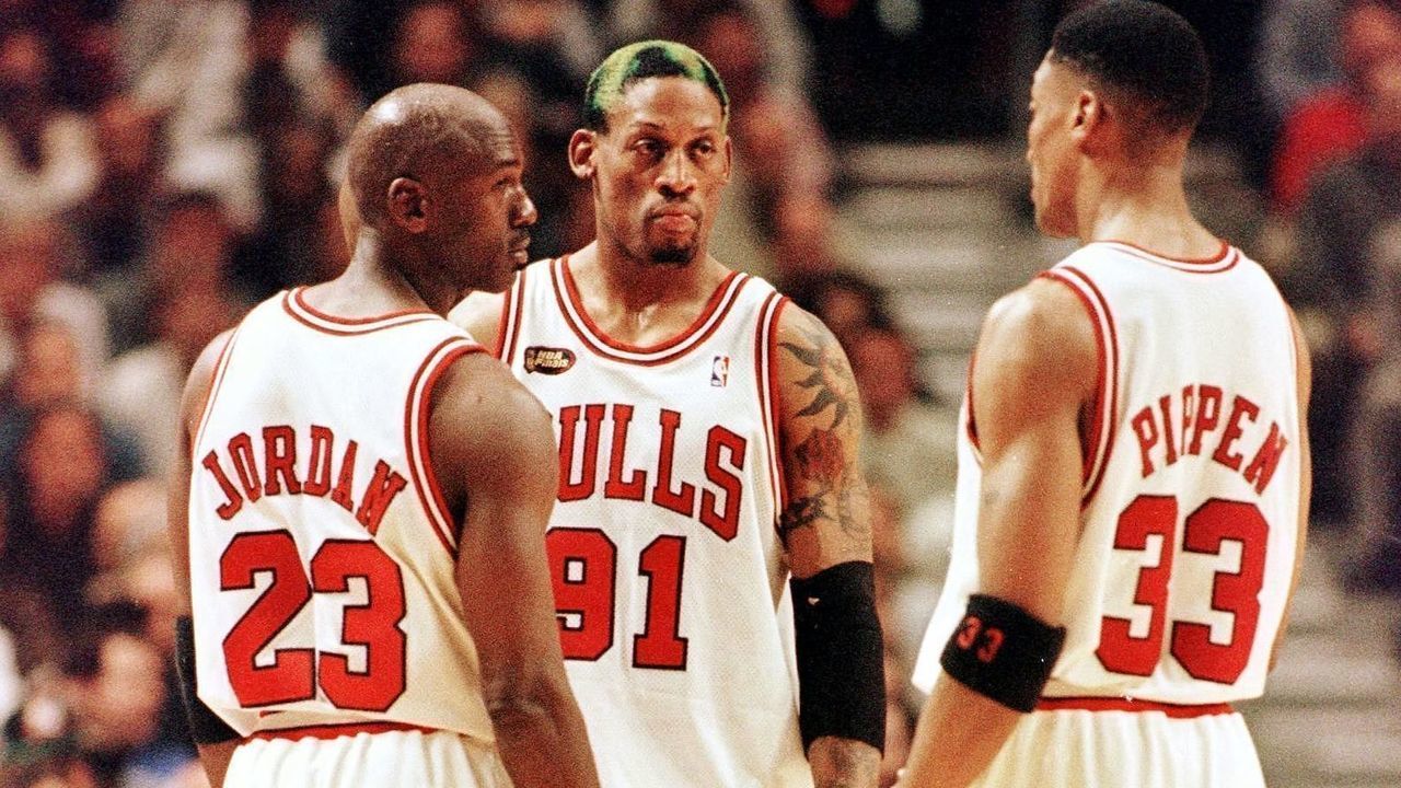 Dennis Rodman of the Chicago Bulls (C) talks to teammates Michael Jordan (L) and Scottie Pippen (L) 10 June during game four of the NBA Finals against the Utah Jazz at the United Center in Chicago, IL. Rodman hit four foul shots down the stretch to lead the Bulls as they beat the Jazz 86-82 to lead the best-of-seven series 3-1. AFP PHOTO/Jeff HAYNES