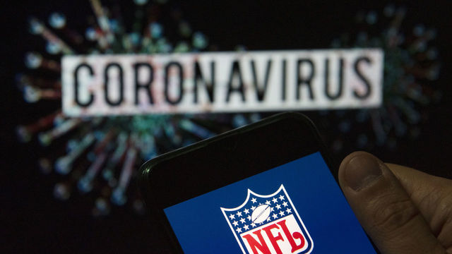 CHINA - 2020/03/24: In this photo illustration the American football league The National Football League (NFL) logo seen displayed on a smartphone with a computer model of the COVID-19 coronavirus on the background. (Photo Illustration by Budrul Chukrut/SOPA Images/LightRocket via Getty Images)
