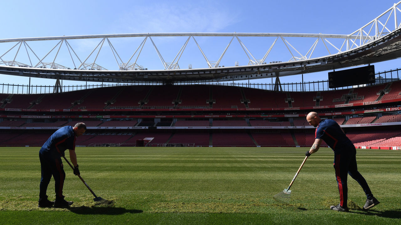 LONDON, ENGLAND - APRIL 21: Groundstaff work on the pitch at Emirates Stadium on April 21, 2020 in London, England.