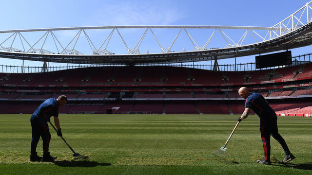 LONDON, ENGLAND - APRIL 21: Groundstaff work on the pitch at Emirates Stadium on April 21, 2020 in London, England.