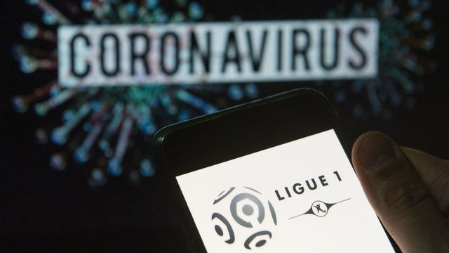 CHINA - 2020/03/24: In this photo illustration the French football professional division Ligue 1 logo seen displayed on a smartphone with a computer model of the COVID-19 coronavirus on the background. (Photo Illustration by Budrul Chukrut/SOPA Images/LightRocket via Getty Images)