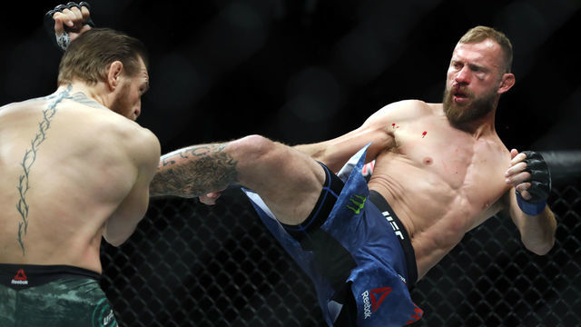 LAS VEGAS, NEVADA - JANUARY 18: Conor McGregor (L) blocks a kick from Donald Cerrone in a welterweight bout during UFC246 at T-Mobile Arena on January 18, 2020 in Las Vegas, Nevada.