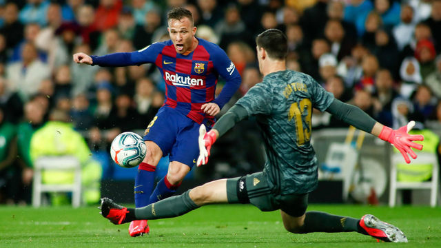 MADRID, SPAIN - MARCH 01: Arthur Henrique Ramos of FC Barcelona and Thibaut Courtois of Real Madrid in action during the Spanish League, La Liga, football match played between Real Madrid CF and FC Barcelona at Santiago Bernabeu stadium on March 01, 2020 in Madrid, Spain.