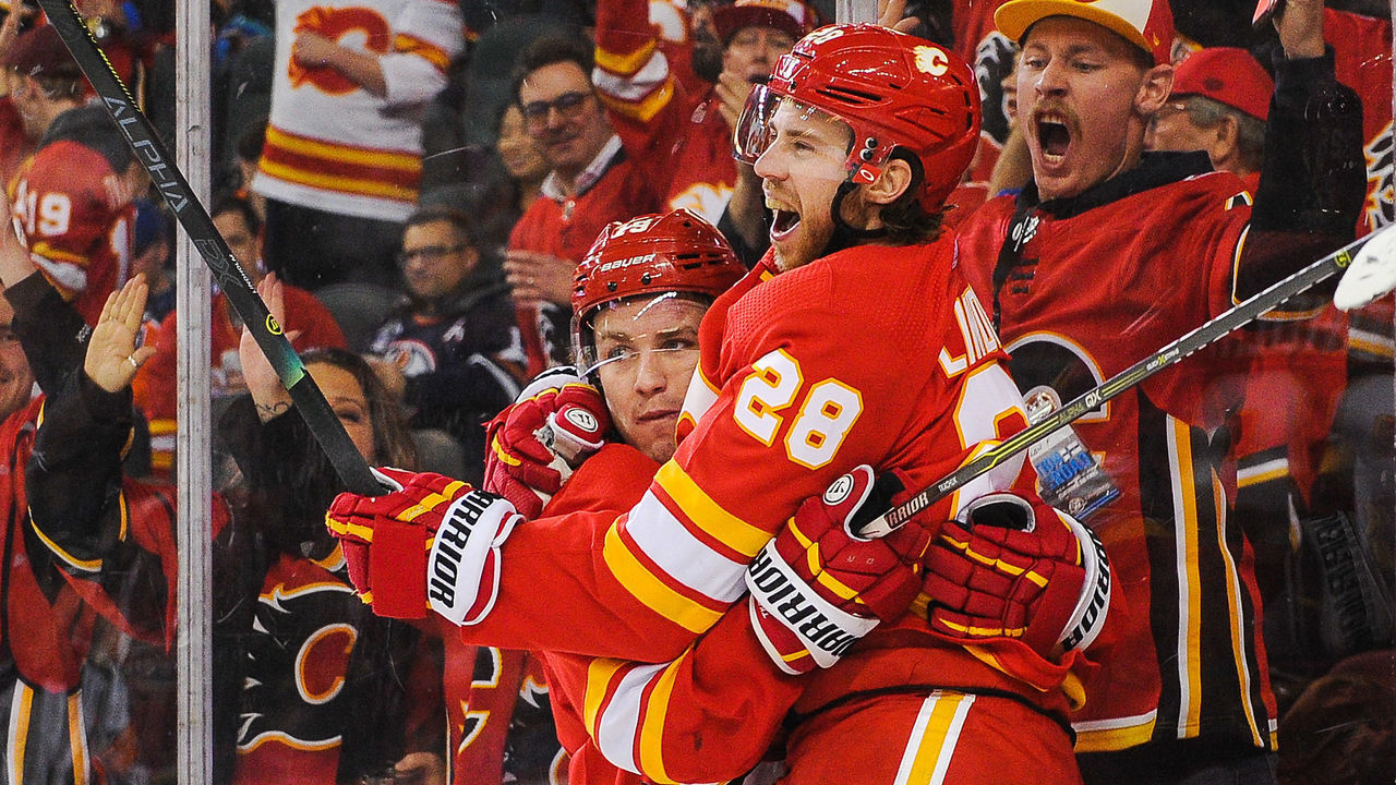 CALGARY, AB - JANUARY 11: Elias Lindholm #28 (R) of the Calgary Flames celebrates after scoring the game-winning goal against the Edmonton Oilers during an NHL game at Scotiabank Saddledome on January 11, 2020 in Calgary, Alberta, Canada.
