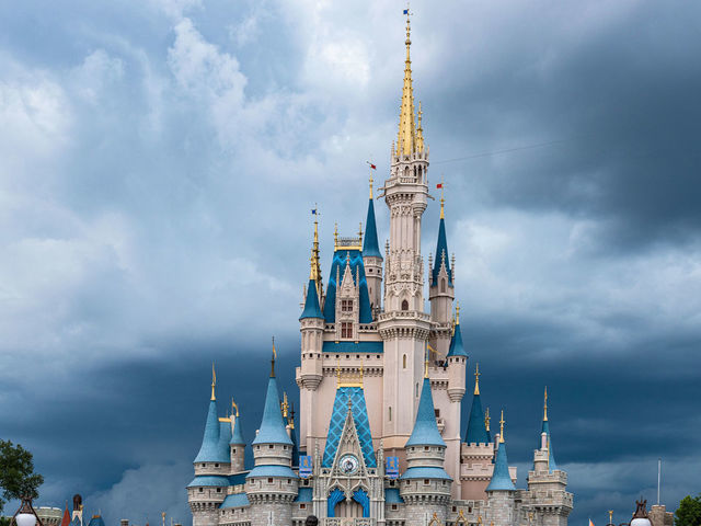 ORLANDO, FLORIDA, UNITED STATES - 2019/07/17: The Cinderella Castle during an overcast day is seen in the Walt Disney's Magic Kingdom theme park. The park is a famous place and tourist attraction.