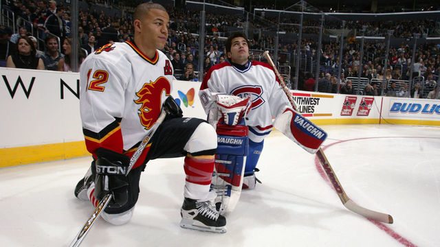 1 Feb 2002: Jarome Iginla of the Calgary Flames and Jose Theodore of the Montreal Canadiens chat during the Dodge NHL SuperSkills competition at the Staples Center in Los Angeles, California. The World defeated North America 21-11. DIGITAL IMAGE. Mandatory Credit: Robert LaBerge/Getty Images/NHLI