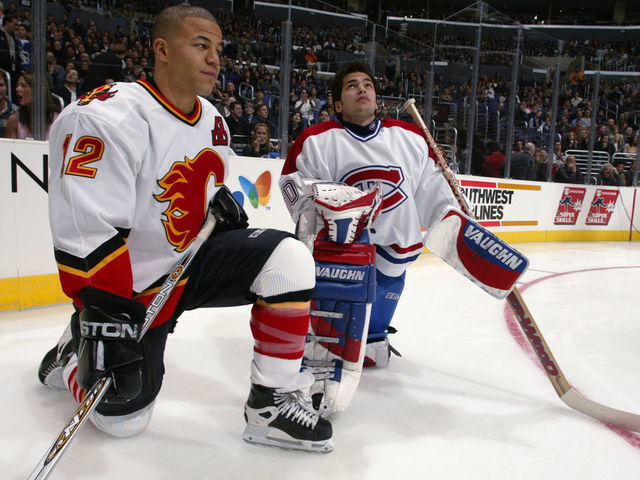 1 Feb 2002: Jarome Iginla of the Calgary Flames and Jose Theodore of the Montreal Canadiens chat during the Dodge NHL SuperSkills competition at the Staples Center in Los Angeles, California. The World defeated North America 21-11. DIGITAL IMAGE. Mandatory Credit: Robert LaBerge/Getty Images/NHLI