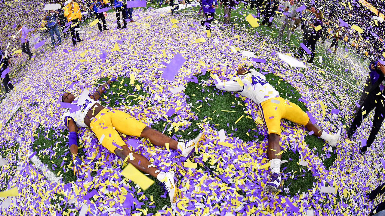 NEW ORLEANS, LOUISIANA - JANUARY 13: Cameron Lewis #31, left, and Michael Divinity Jr. #45 of the LSU Tigers make confetti angels after the College Football Playoff National Championship game against the Clemson Tigers at the Mercedes Benz Superdome on January 13, 2020 in New Orleans, Louisiana. The LSU Tigers topped the Clemson Tigers, 42-25.