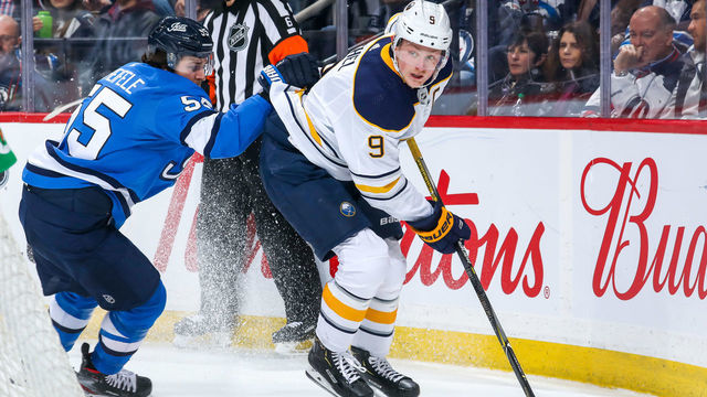 WINNIPEG, MANITOBA - MARCH 03: Jack Eichel #9 of the Buffalo Sabres plays the puck behind the net while Mark Scheifele #55 of the Winnipeg Jets gives chase during third period action at Bell MTS Place on March 03, 2020 in Winnipeg, Canada.