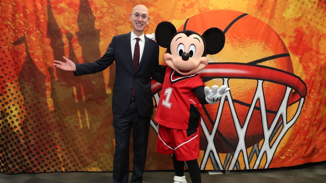 CHARLOTTE, NC - FEBRUARY 15: NBA Commissioner, Adam Silver and Mickey Mouse meet during NBA All Star Weekend in Charlotte, North Carolina on February 15, 2019 at Bojangles Coliseum. The NBA is collaborating with Walt Disney Imagineering on the new NBA Experience opening this summer at Walt Disney World Resort in Florida. This one-of-a-kind destination will bring NBA moments to life through thrilling basketball activities and interactive experiences that will appeal to boys, girls and adults. Mandatory Copyright Notice: Copyright 2019 NBAE