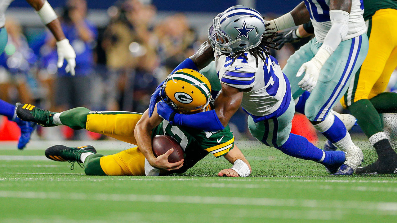 ARLINGTON, TX - OCTOBER 06: Green Bay Packers quarterback Aaron Rodgers (12) is sacked by Dallas Cowboys middle linebacker Jaylon Smith (54) during the game between the Green Bay Packers and Dallas Cowboys on October 6, 2019 at AT&T Stadium in Arlington, TX.